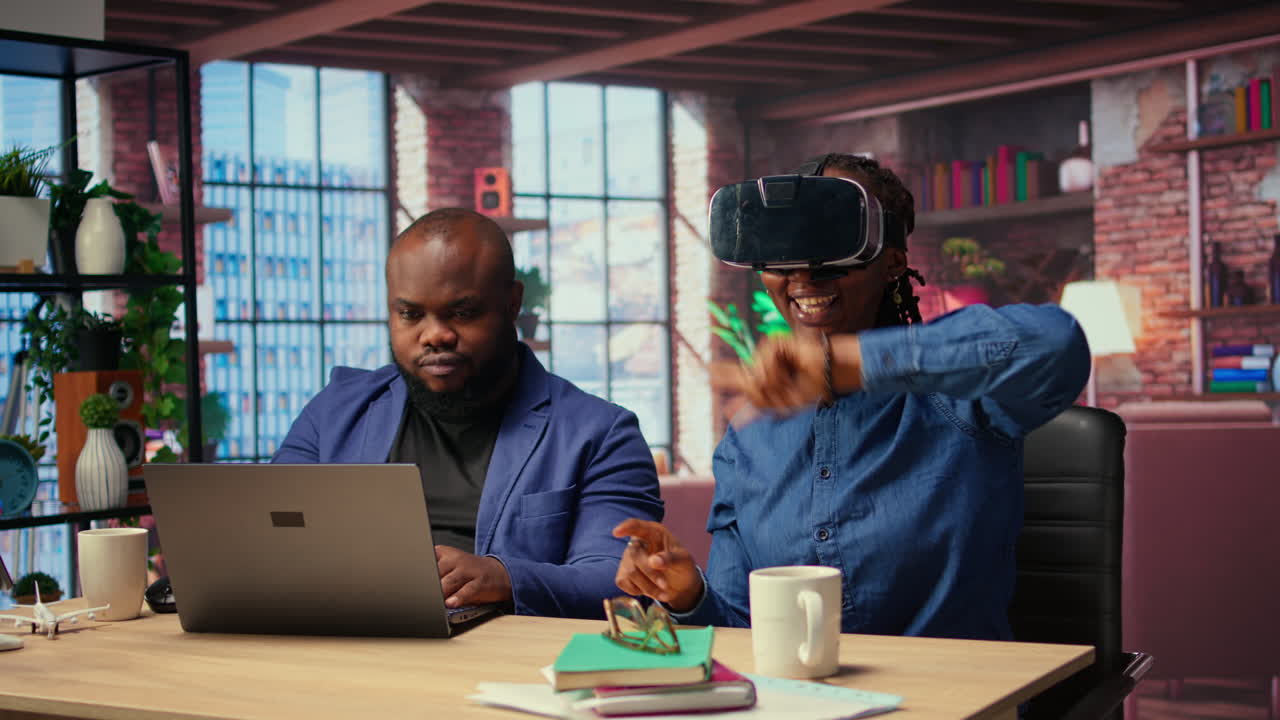 Woman interacts with VR while her boyfriend completes the 3D animation