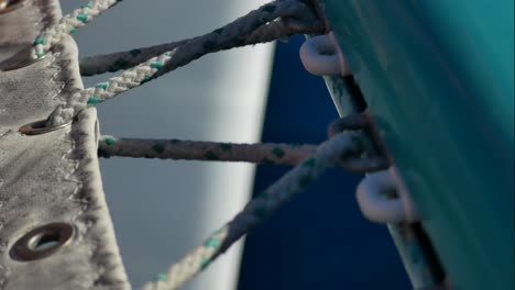 close-up of the rope that tightens the canvasof a catamaran´s bow