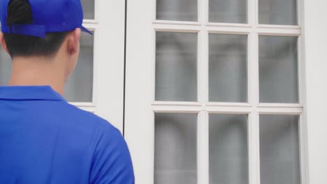 delivery person signing package at the door