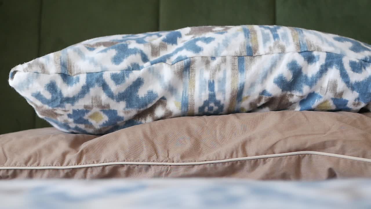 Close-up of a bed with patterned pillow and bedding