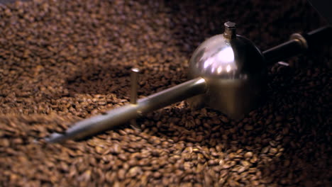 coffee beans mixing in cooling drum after being freshly roasted