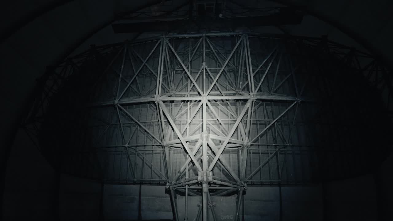 Large Radar Dish Rotating Inside a Dark Dome