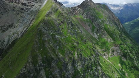 flying over mountain top in valmalenco valley during summer season