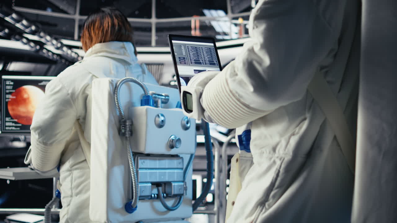 Close up of astronaut using tablet to check logs after completing Mars mission