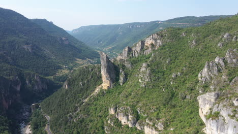 Long-aerial-flight-over-a-rocky-peak-with-climbers-adventure-sports-France