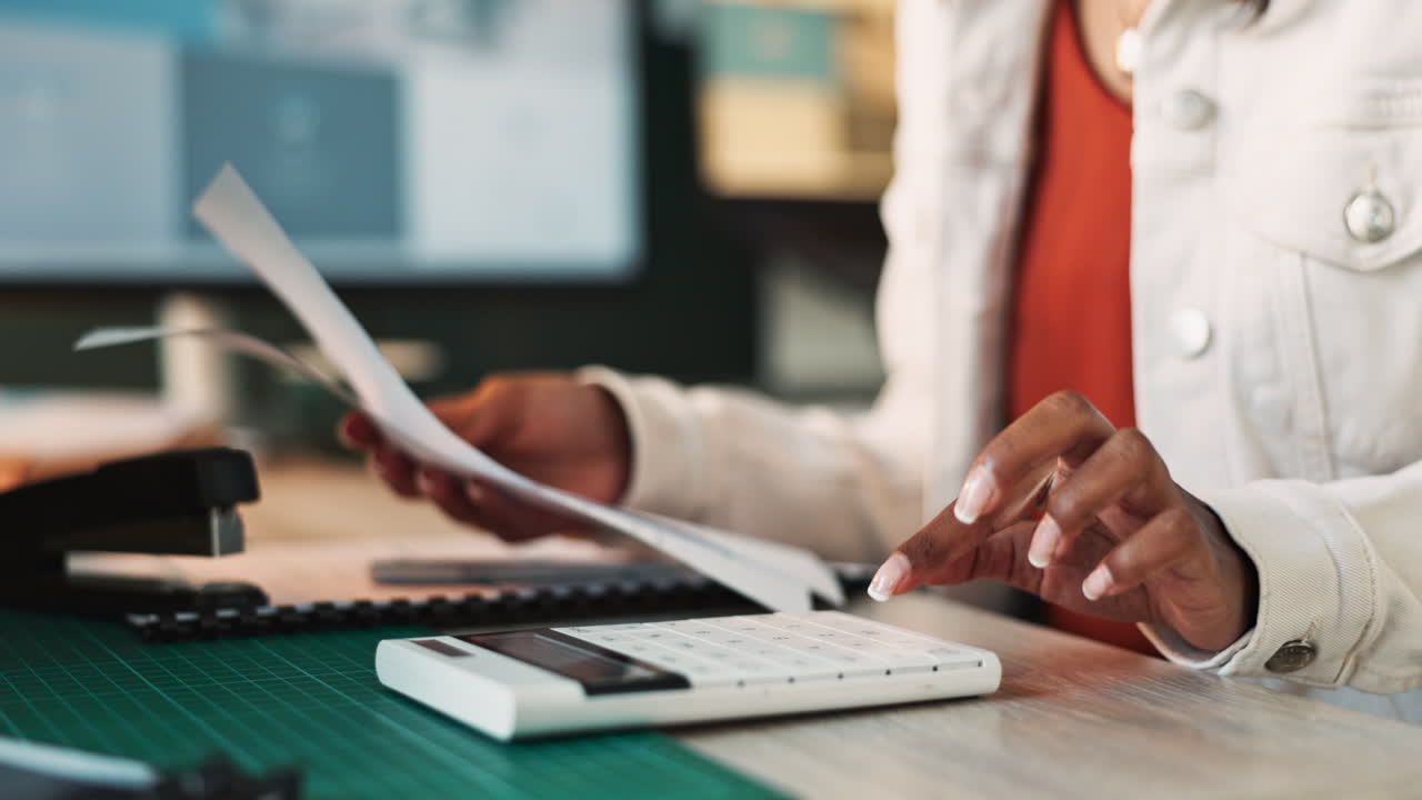 Business woman using calculator