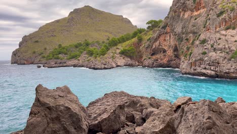 Waves-Hits-Cliff-Mountains-At-Sa-Calobra-Mallorca,-Spain,-Scenic-View,-Pan-Left