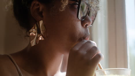 close-up view of fashionable african woman drinking lemonade