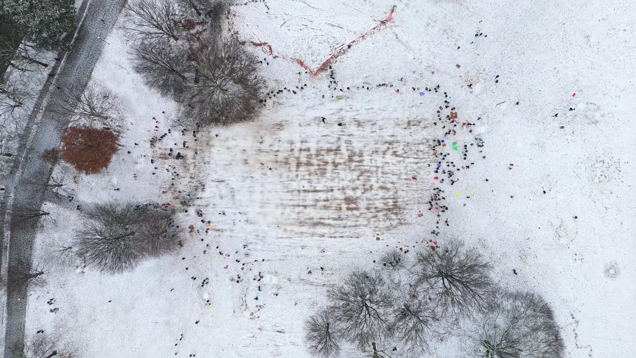Aerial top down shot of people sledding in Piedmont Park Atlanta on January 10th 2025.