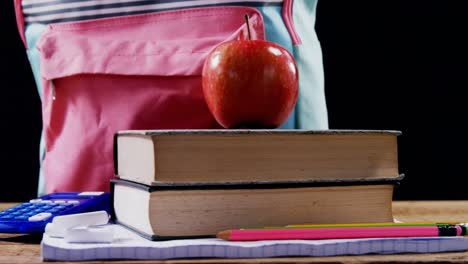Apple-on-book-stack-with-schoolbag