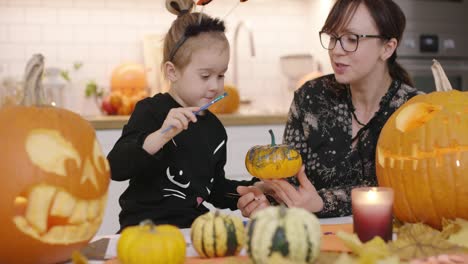 Woman-holding-painted-pumpkin