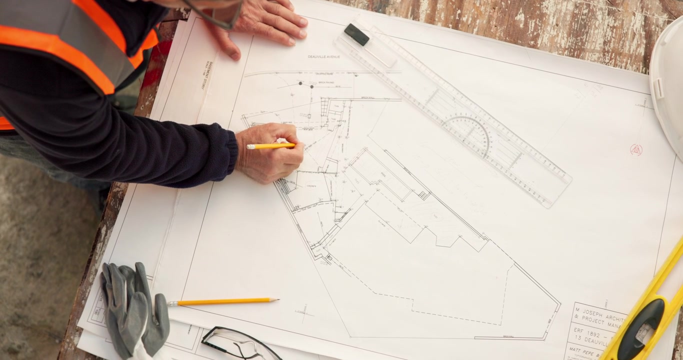 Architect Reviewing Construction Blueprints on Site