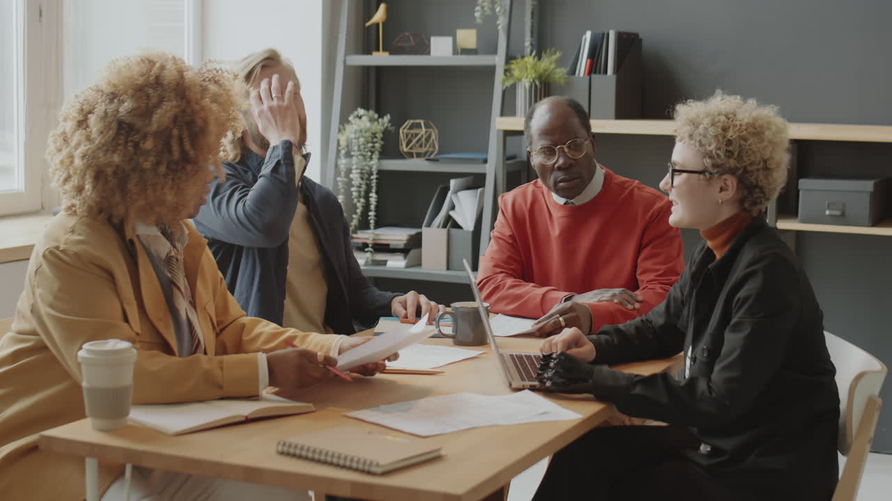 Woman with Prosthetic Arm Using Laptop at Business Meeting