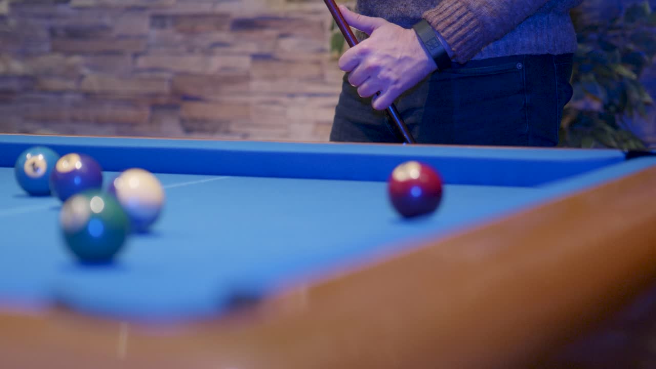 Snooker players chalking snooker stick