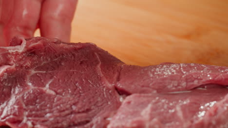 preparing raw beef steaks