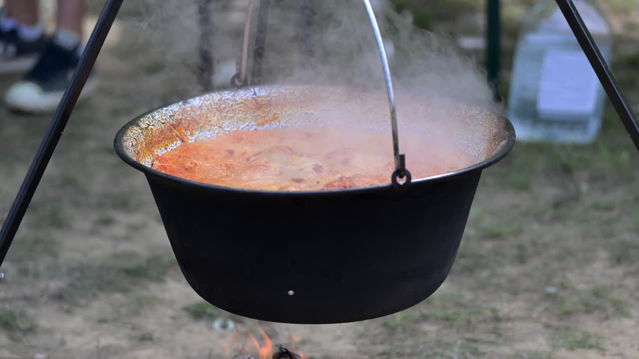 Traditional goulash cooking outdoors in cauldron