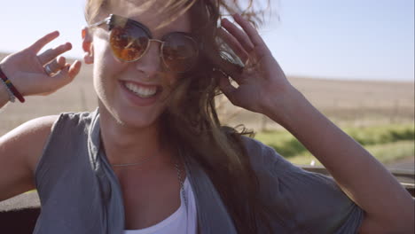 beautiful girl on adventure road trip in vintage convertible enjoying the wind in her hair