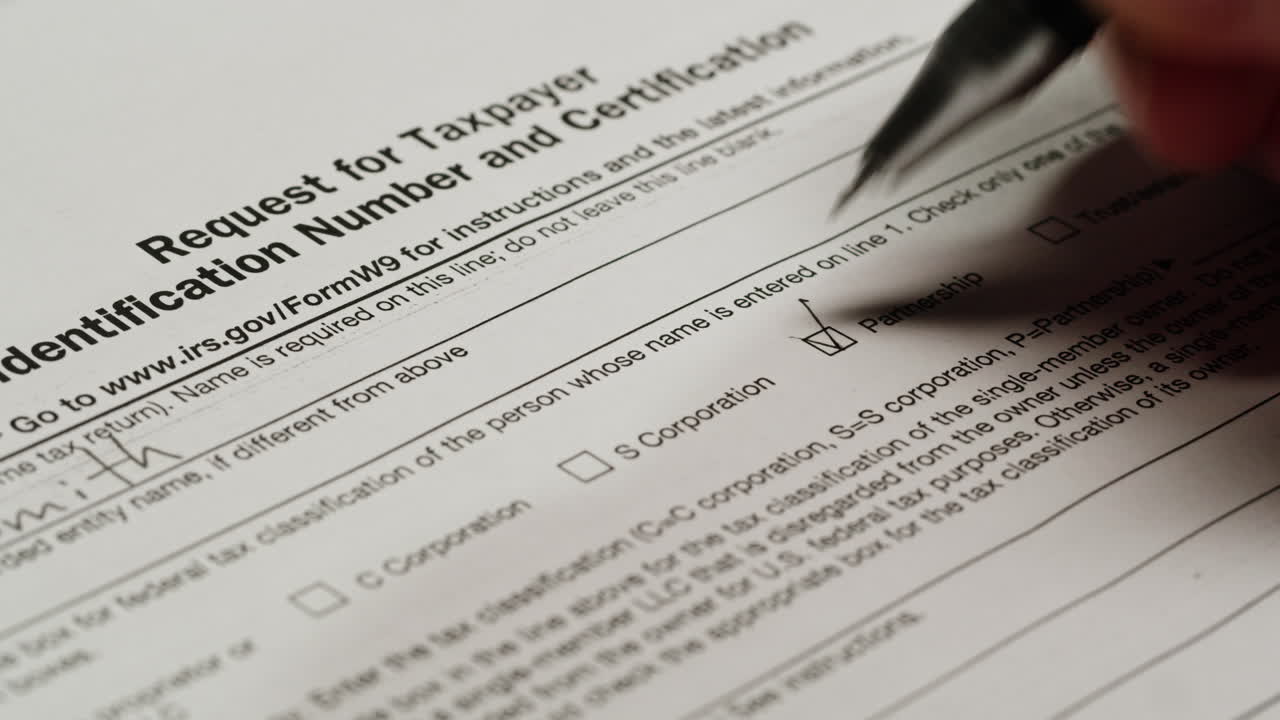 Hand Checking Partnership Box on IRS W-9 Tax Form