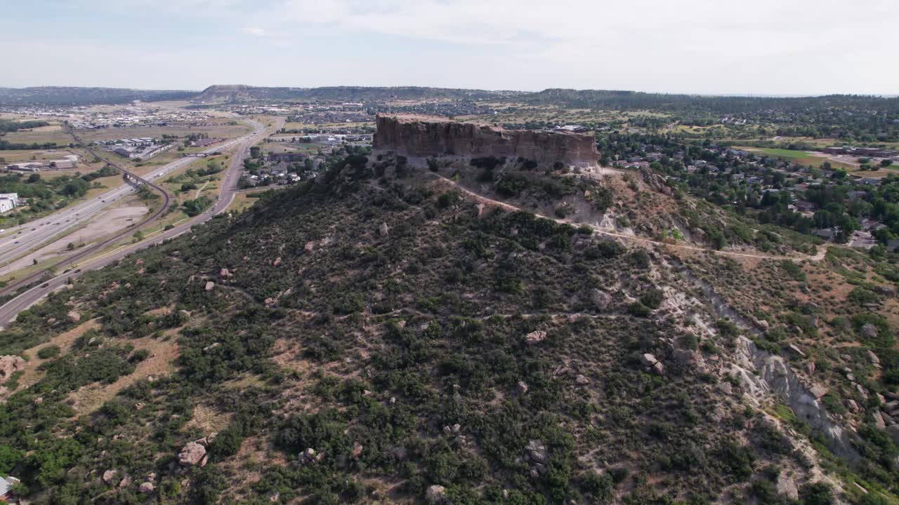 Aerial video of the famous Castle Rock Park in Castle Rock, Colorado. Camera is heading approximately north out of the city toward Castle Rock Park