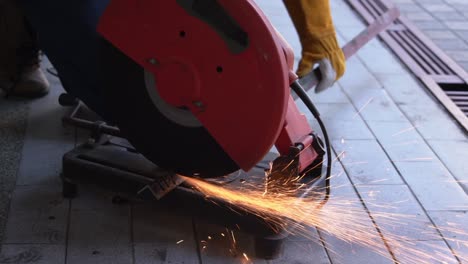 Professional-mechanic-is-cutting-steel-metal.