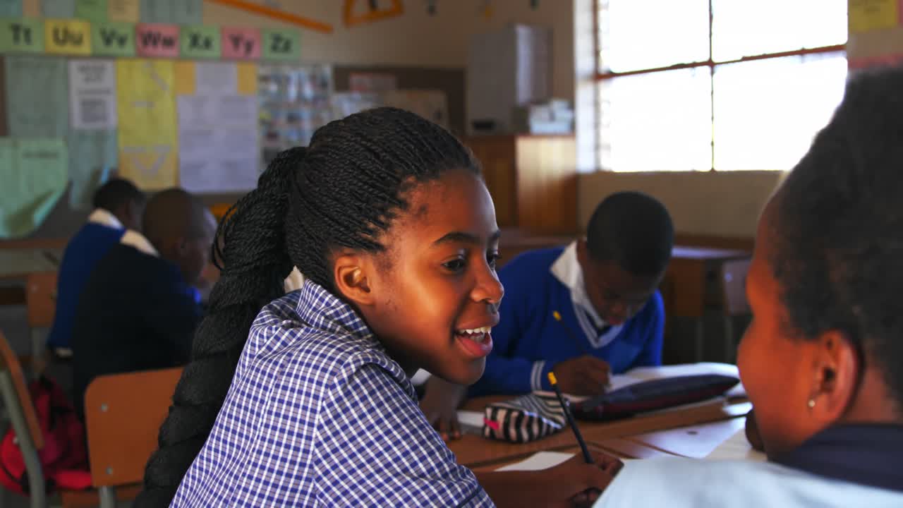 Schoolgirls talking in a lesson at a township school 4k