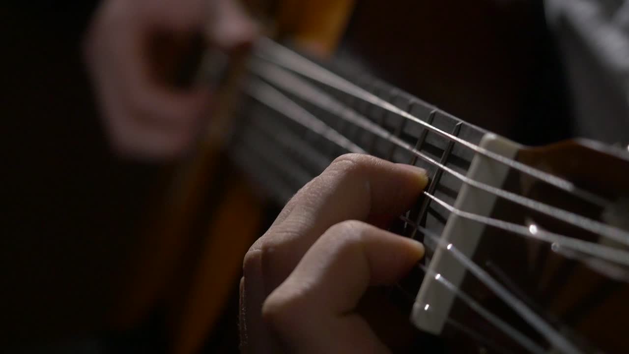 Close-up of someone playing an acoustic guitar