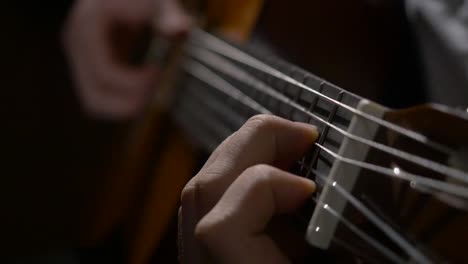 close-up of someone playing an acoustic guitar