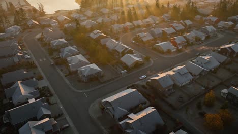 Drone-view-of-a-suburban-neighborhood-during-winter-while-the-sun-is-rising