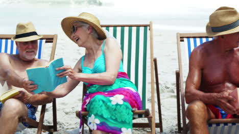 Senior-friends-sitting-in-beach-chair