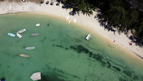 Bird-Eye-Aerial-Shot-of-many-Boats-Floating-On-Top-Of-Beautiful-Blue-Water