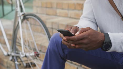 african american man using his phone in the street