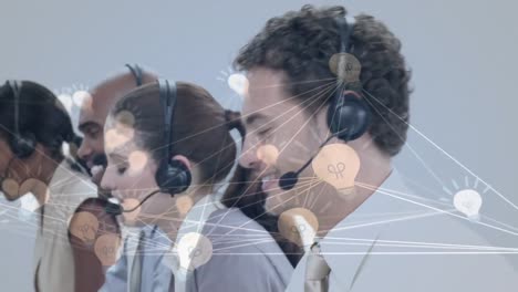 Animation-of-network-of-connection-with-icons-over-business-people-wearing-phone-headsets