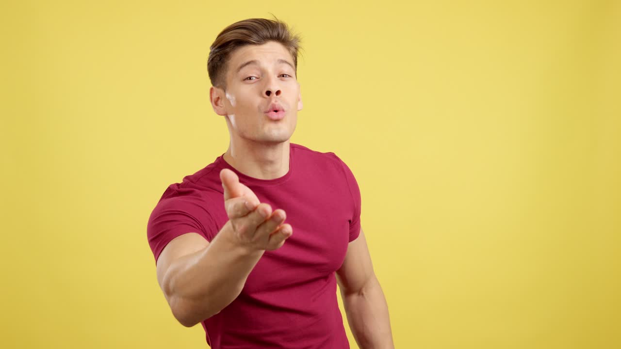 Man Blowing a Kiss on Yellow Background