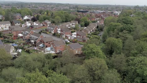 quiet british homes and gardens residential suburban property aerial view orbit left above trees