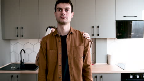 Smiling-Woman-Helping-A-Blind-Man-To-Clean-His-Clothes-With-Lint-Roller-At-Home