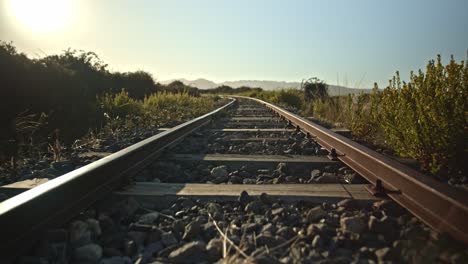 golden sunrise across deserted train tracks in a rural setting