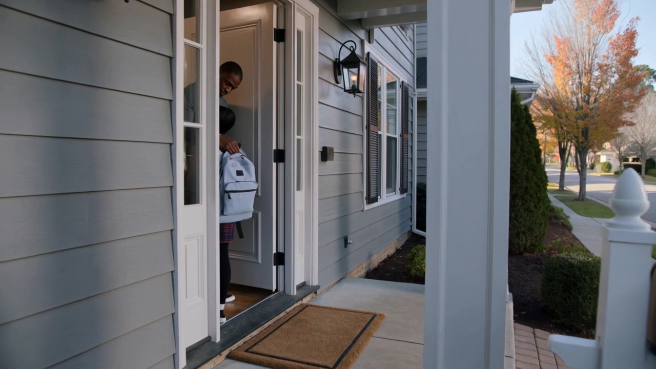 Door opening, woman in casual wear stepping onto porch, adjusting white backpack leaving to commute