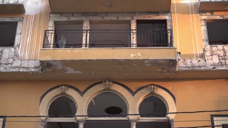 windows and balconies of residential building in city district