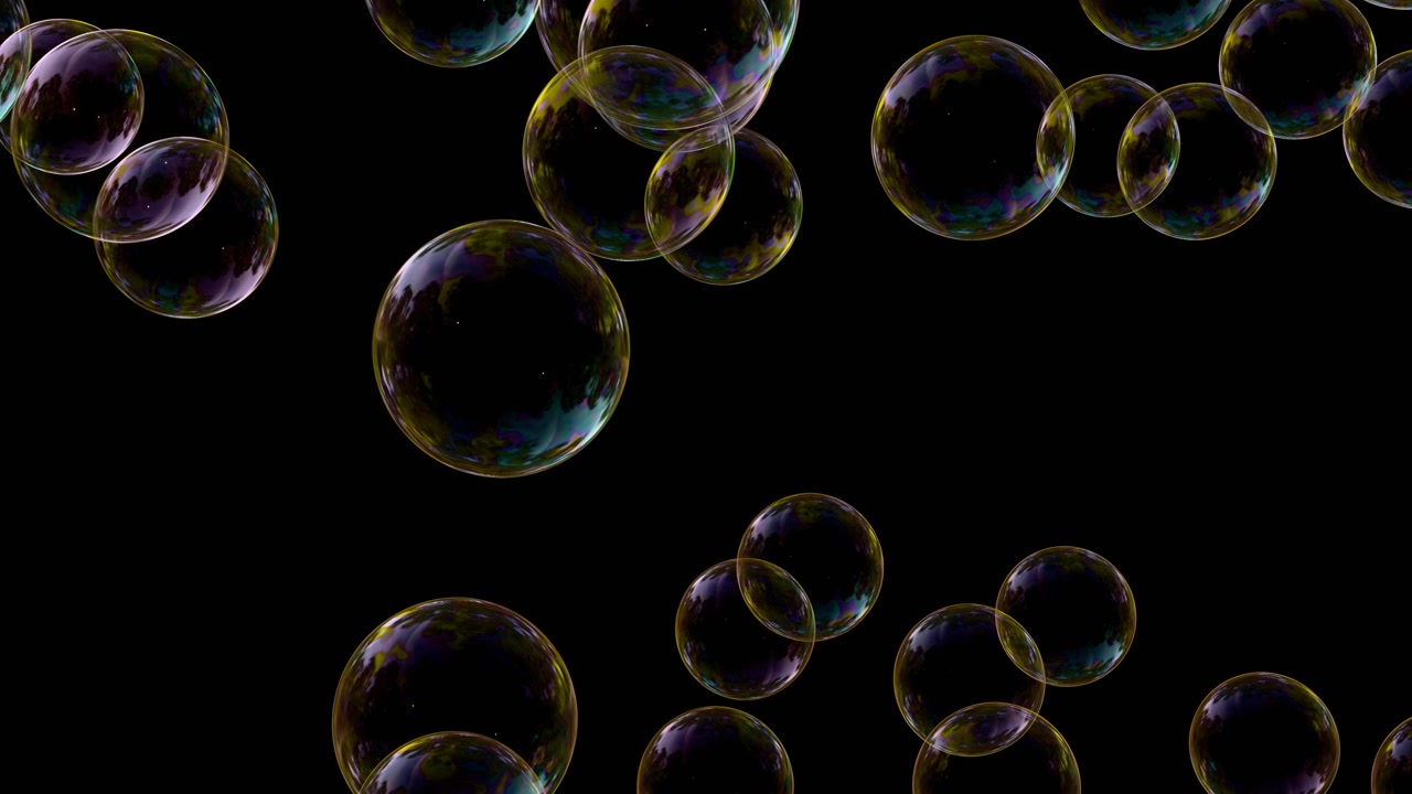 Iridescent soap bubbles floating on a solid black background