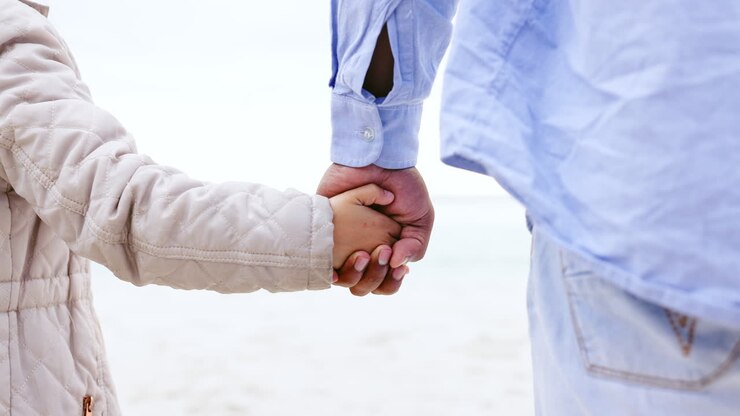 Father, kid and holding hands in closeup
