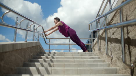 woman stretching outdoors on stairs