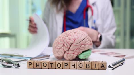 medical concept of photophobia with a brain model and doctor