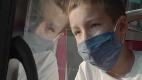 tired boy wearing mask in the bus