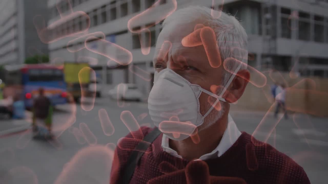 フェイスマスクを着た男の上を移動するコビッド19細胞のアニメーション