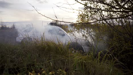 a vehicle with mechanical problems is on the side of the road in an area with grass