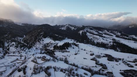 hills and forests covered in white snow near touristic village of voskopoja in albania