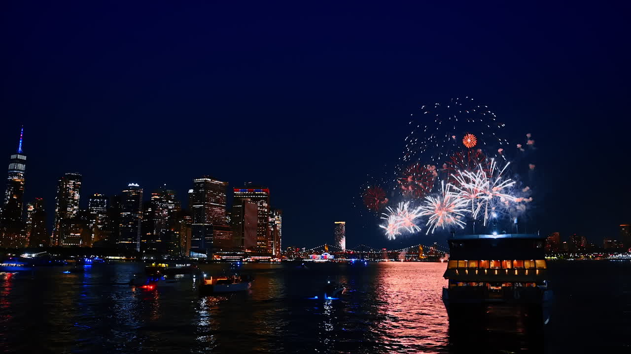 Fireworks in New York on the Independence Day. People enjoy the show on the riverboats