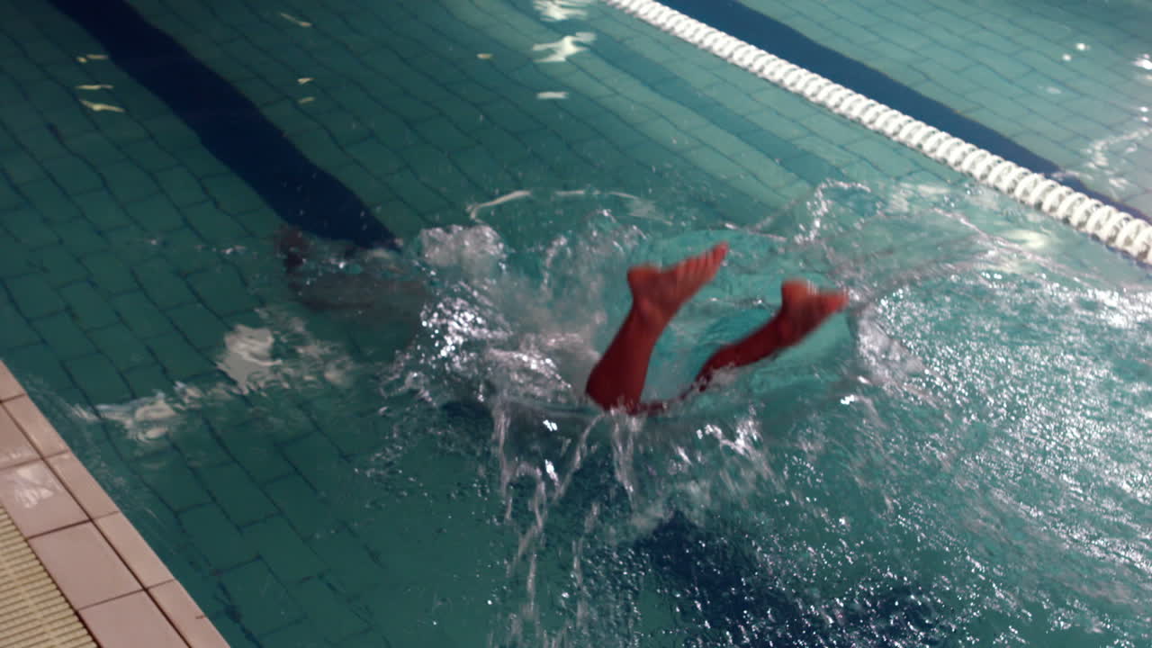 Cropped view of swimmer diving into pool