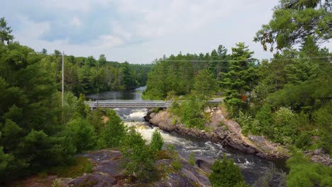 aerial of scenic waterway passing under a roadway bridge in upper canada