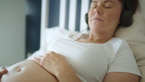 Close-up-video-of-woman-pregnant-listening-to-music.